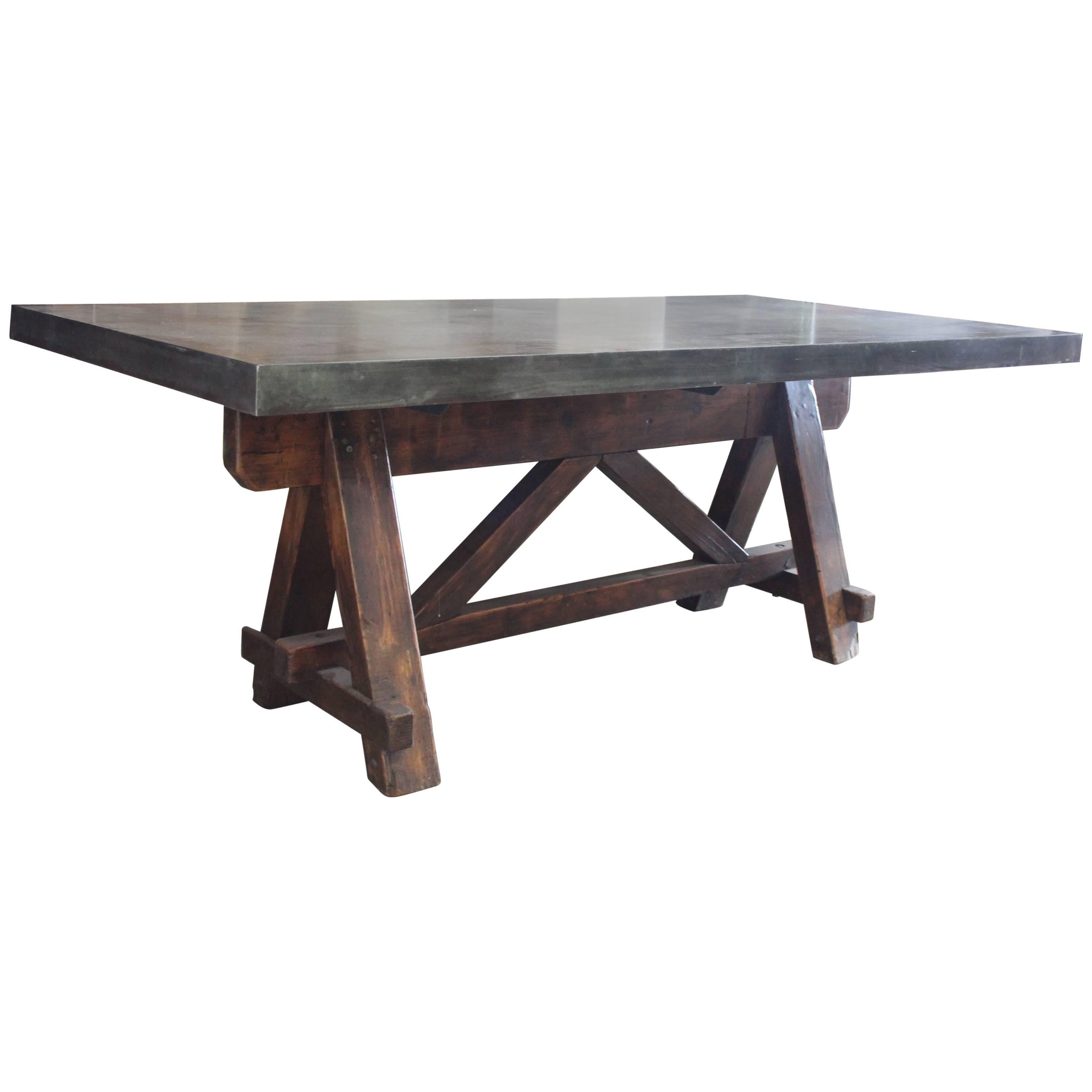 Vintage French Tradesman's Sawhorse as dining table with patinated zinc top.