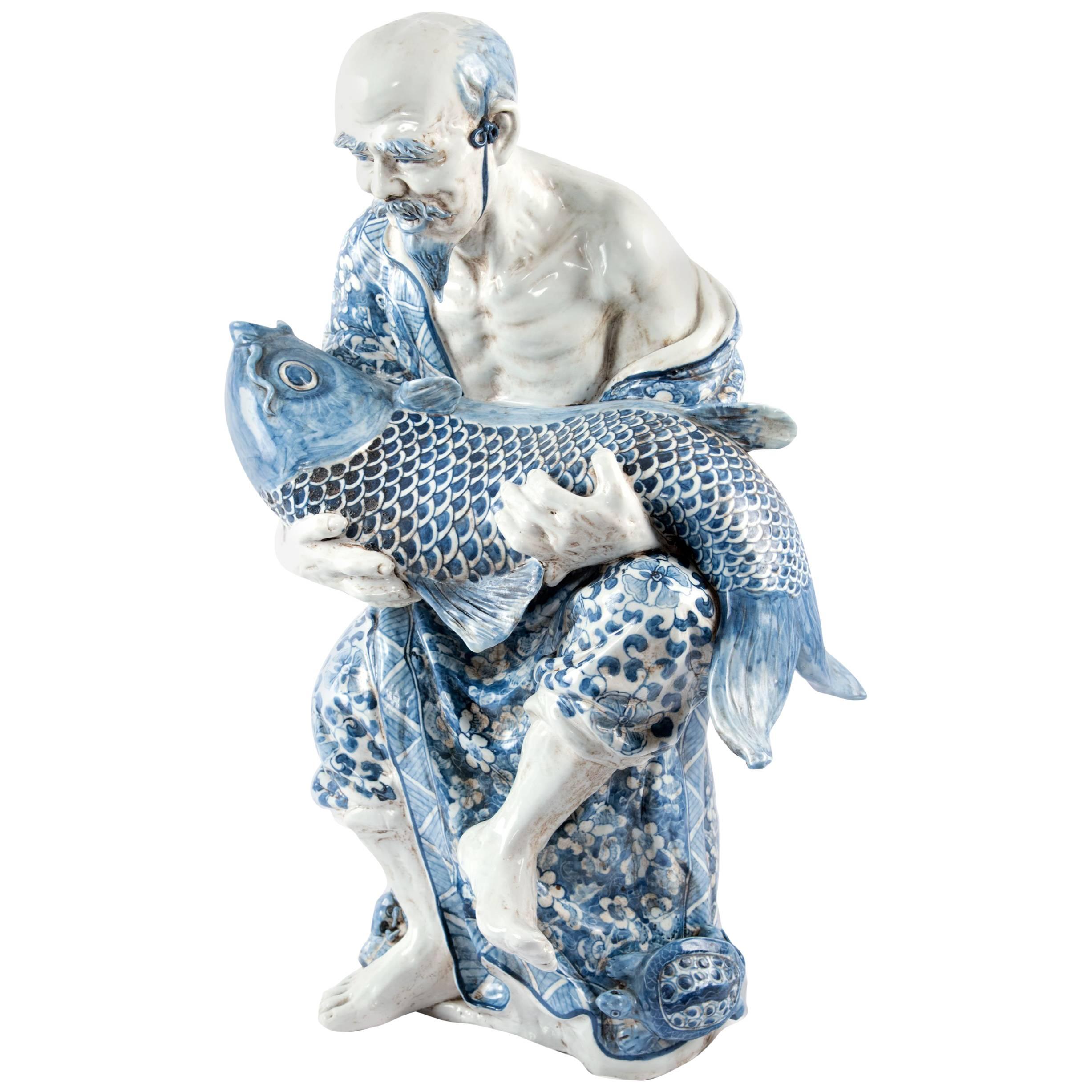 Blue and White Chinese Porcelain Man and Fish Sculpture at 1stDibs