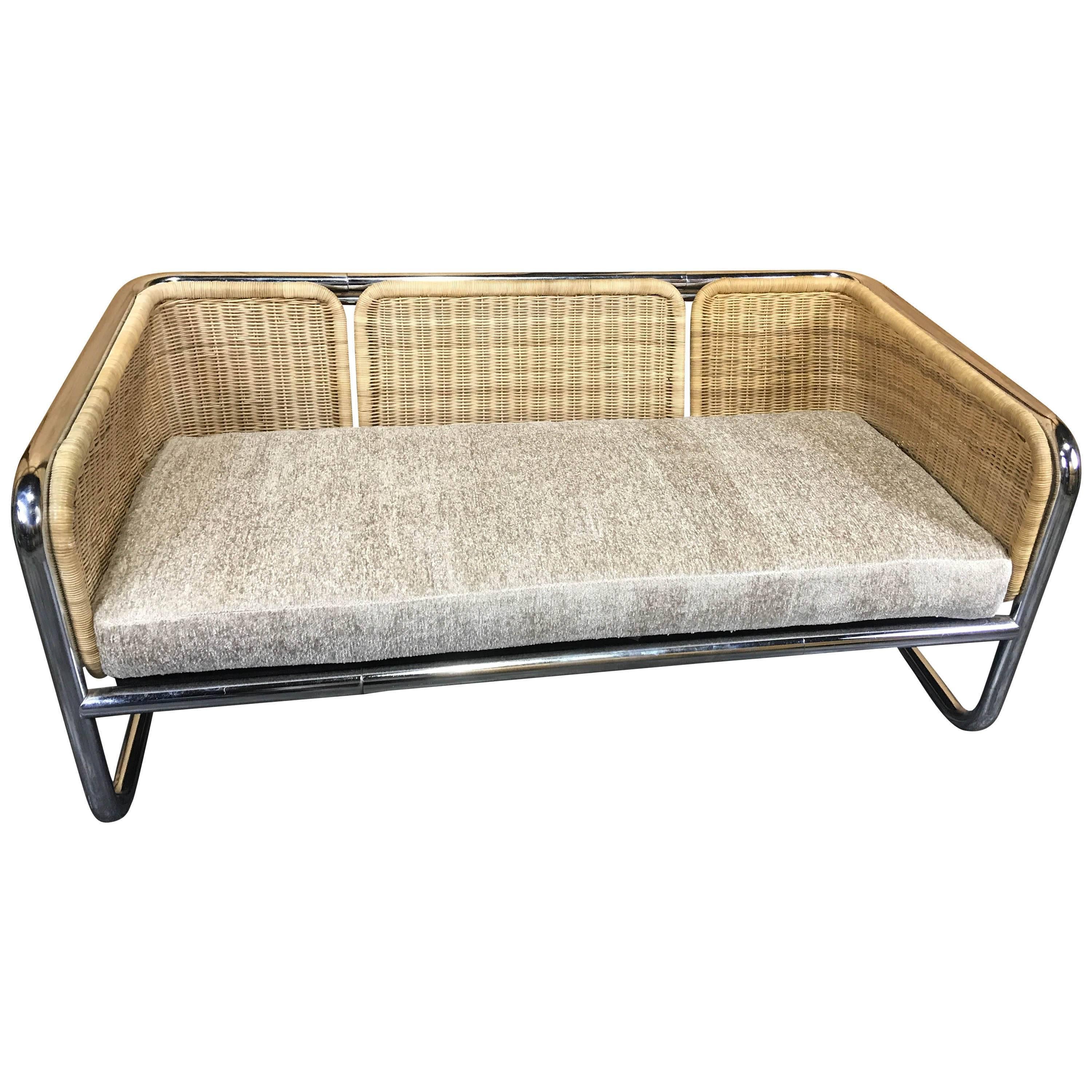 Martin Visser wicker and chrome cantilever couch, with bright and shiny chrome, strong wicker bucket seat with newly upholstered seat and seat cushions.
The sofa measures 27