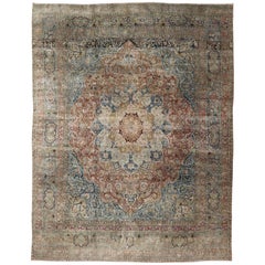 Grand tapis persan ancien Mashad à motifs floraux et médaillons colorés