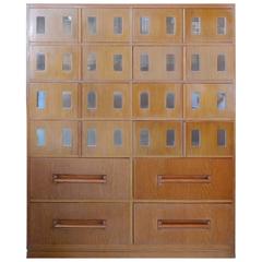American 1950s 12-drawer wood and glass cabinet
