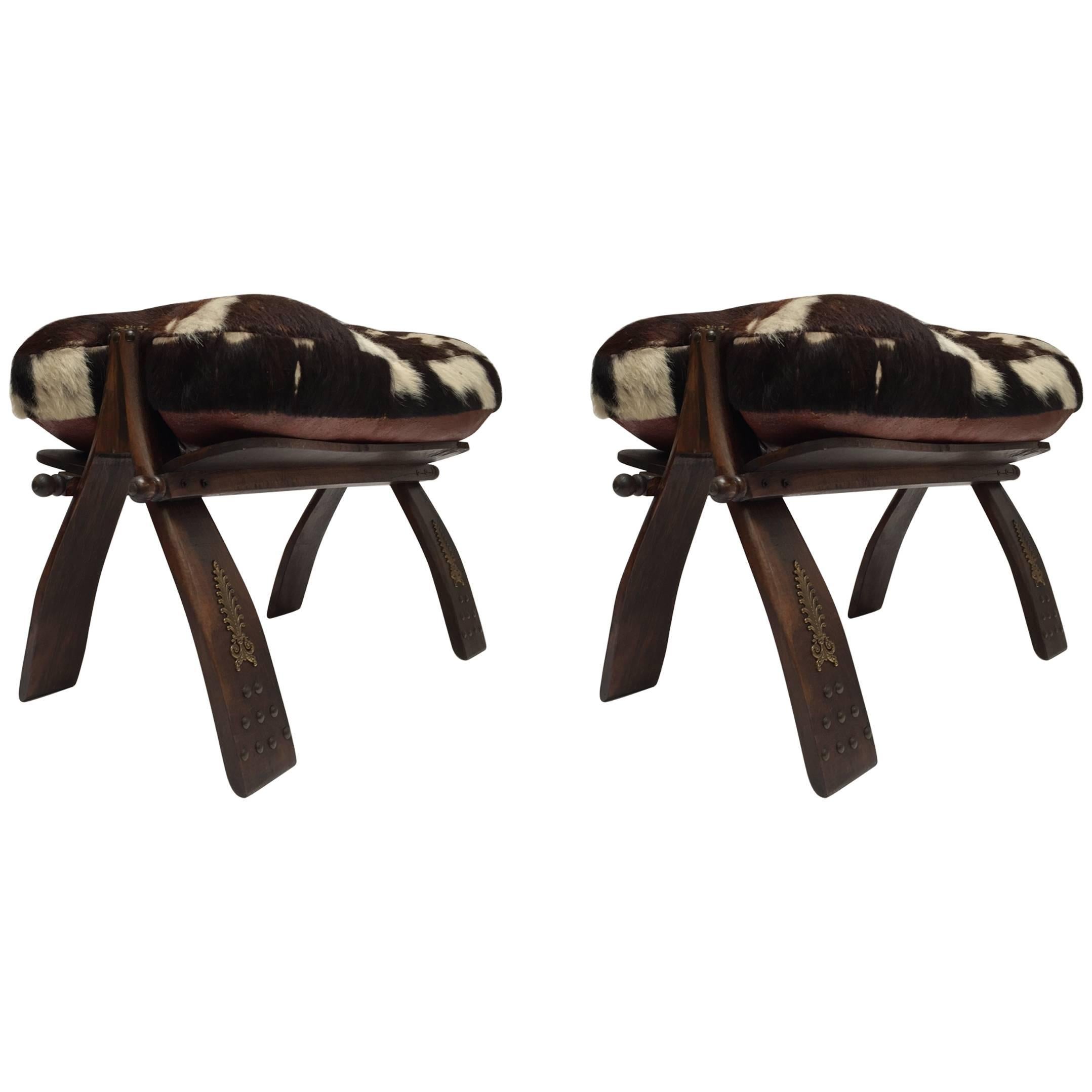Pair of Camel Saddle Seat Footstools with Cowhide Cushions