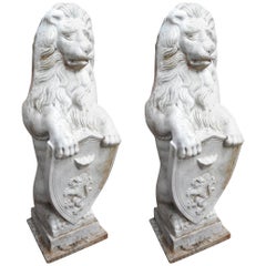 Pair of Cast Iron Lion Statues Holding a Shield