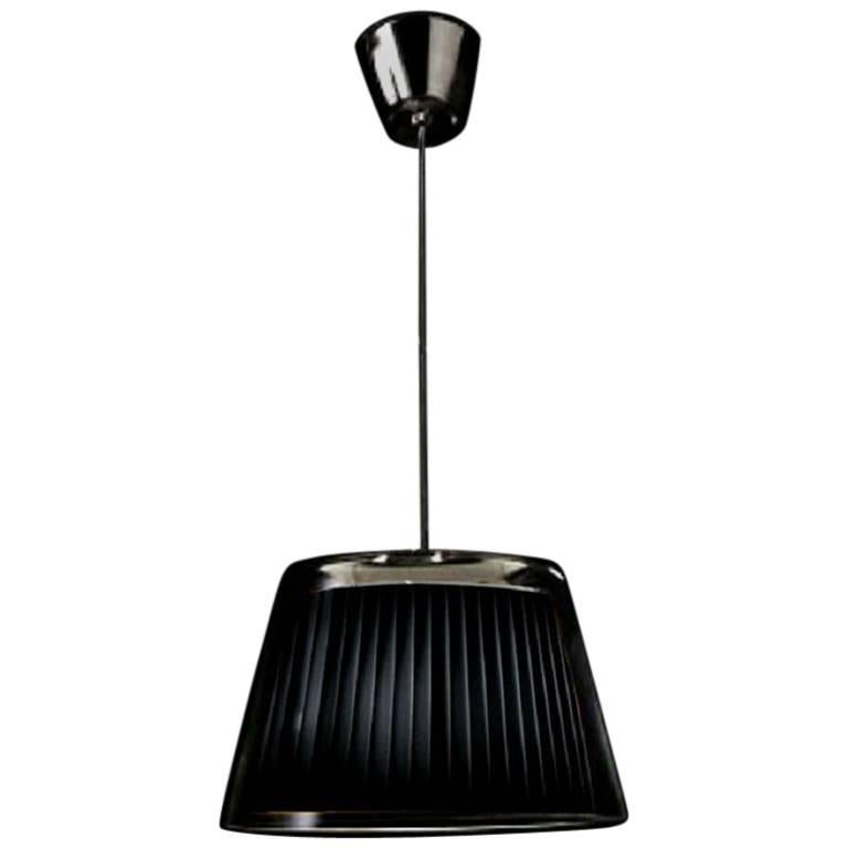 This elegant Gretta IC30 pendant by Alfonso Fontal for Modiss feature a black fabric shade covered by handblown glass. Please note the glass canopy cover is missing. A great look, and your shade will be preserved for all time. Made in Spain.

It is