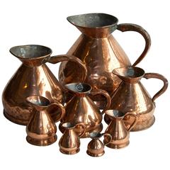 Set of Eight Antique Graduated English Haystack Copper Jugs