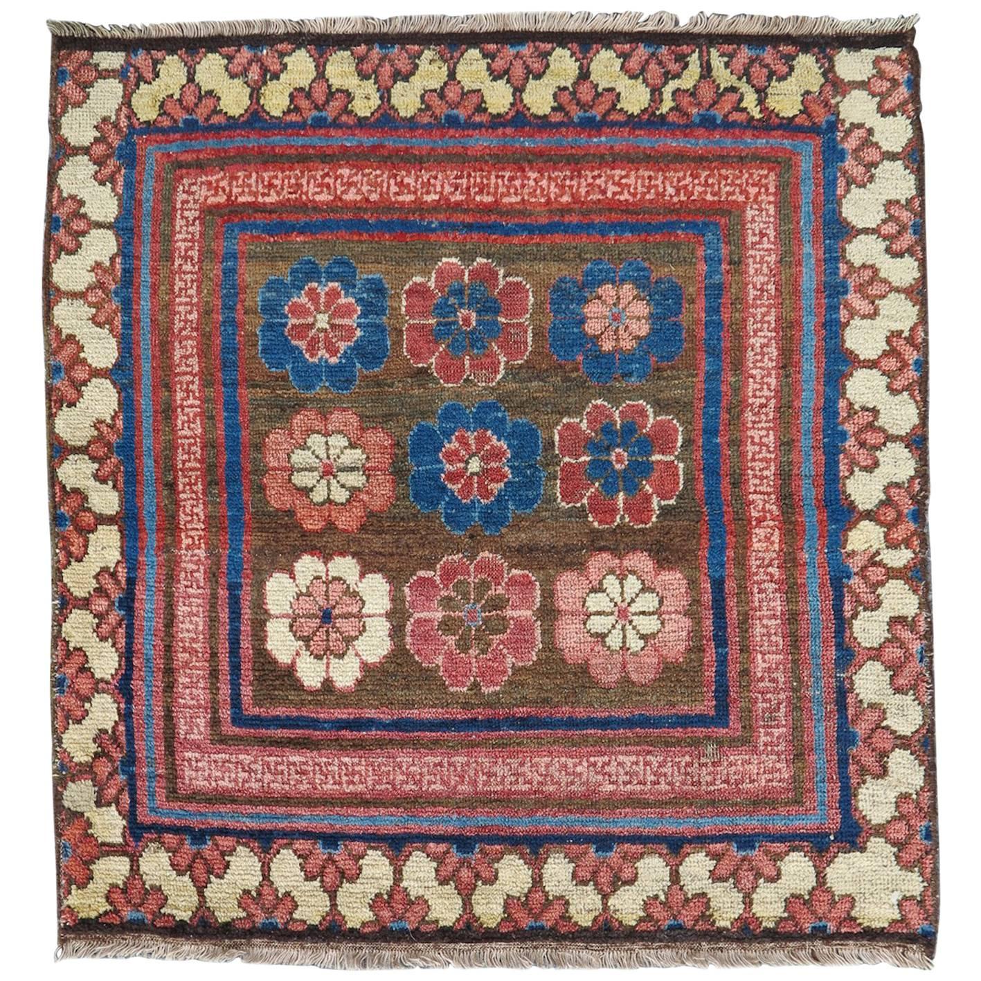 Early 19th Century Rose and Blue Khotan Fragment Rug For Sale