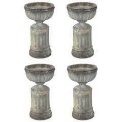 Set of Four Large English Stone Urns on Plinths