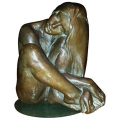 Bronze Sculpture of a Nude Seated Woman with Long Flowing Hair