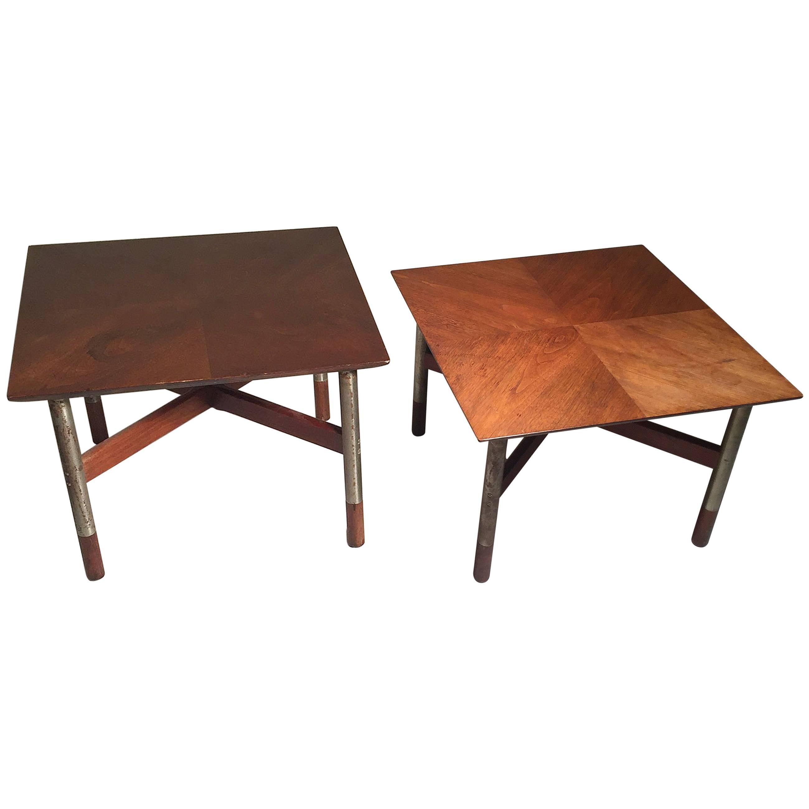 Mid-Century Walnut and Brushed Steel Pair of Tables by Jack Cartwright.  Model number printed on underside of one of them. Steel legs with teak-capped feet. Wood X-stretcher on each. 

In the manner of Finn Juhl , Arne Vodder and Milo Baughman