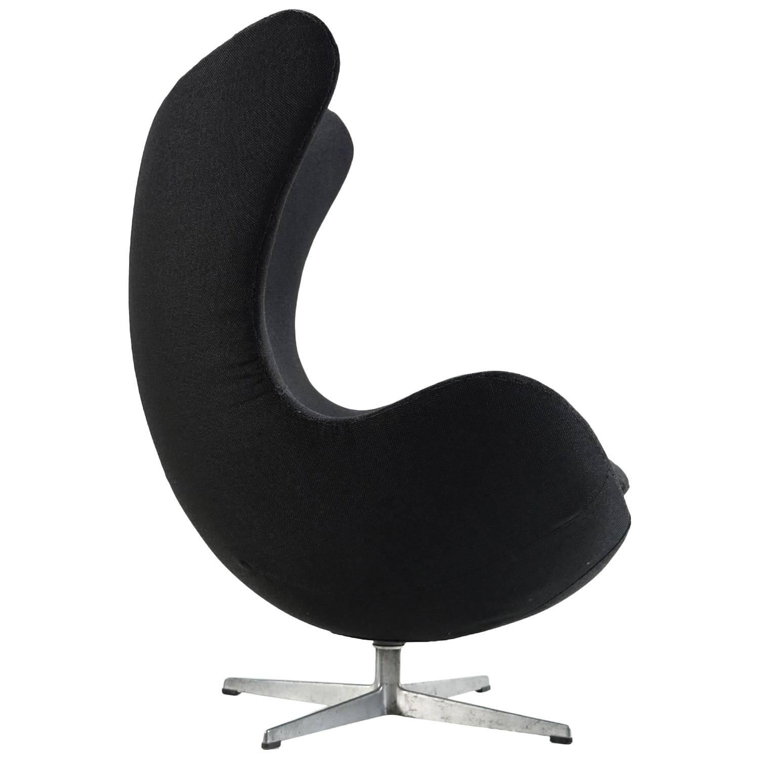 Authentic Mid-Century Modern Arne Jacobsen for Fritz Hansen Egg chair. The chair has been restored with new padding covering the original shell and new upholstery. The base bears the maker's mark. Covered in new black fabric, this chair is certain