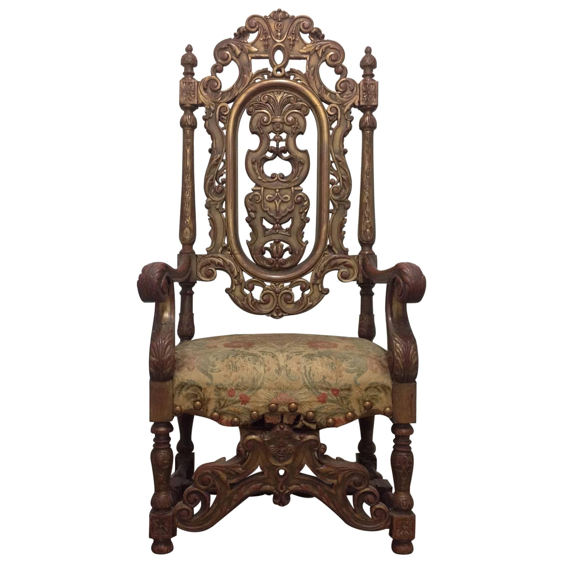 Heavily carved wood late 19th century Italian palatial and regal armchair with its original antique floral velvet brocade tapestry seat covering. Very faded on the top of the seat, the antique tapestry still has vibrancy in the front and back and is
