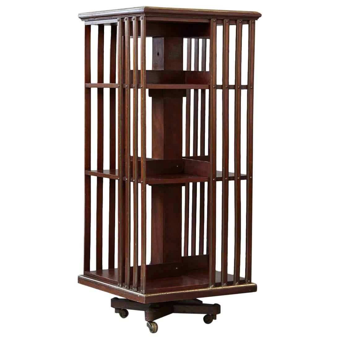 Antique French Revolving Mahogany Bookcase on Raised Casters with Brass Trim