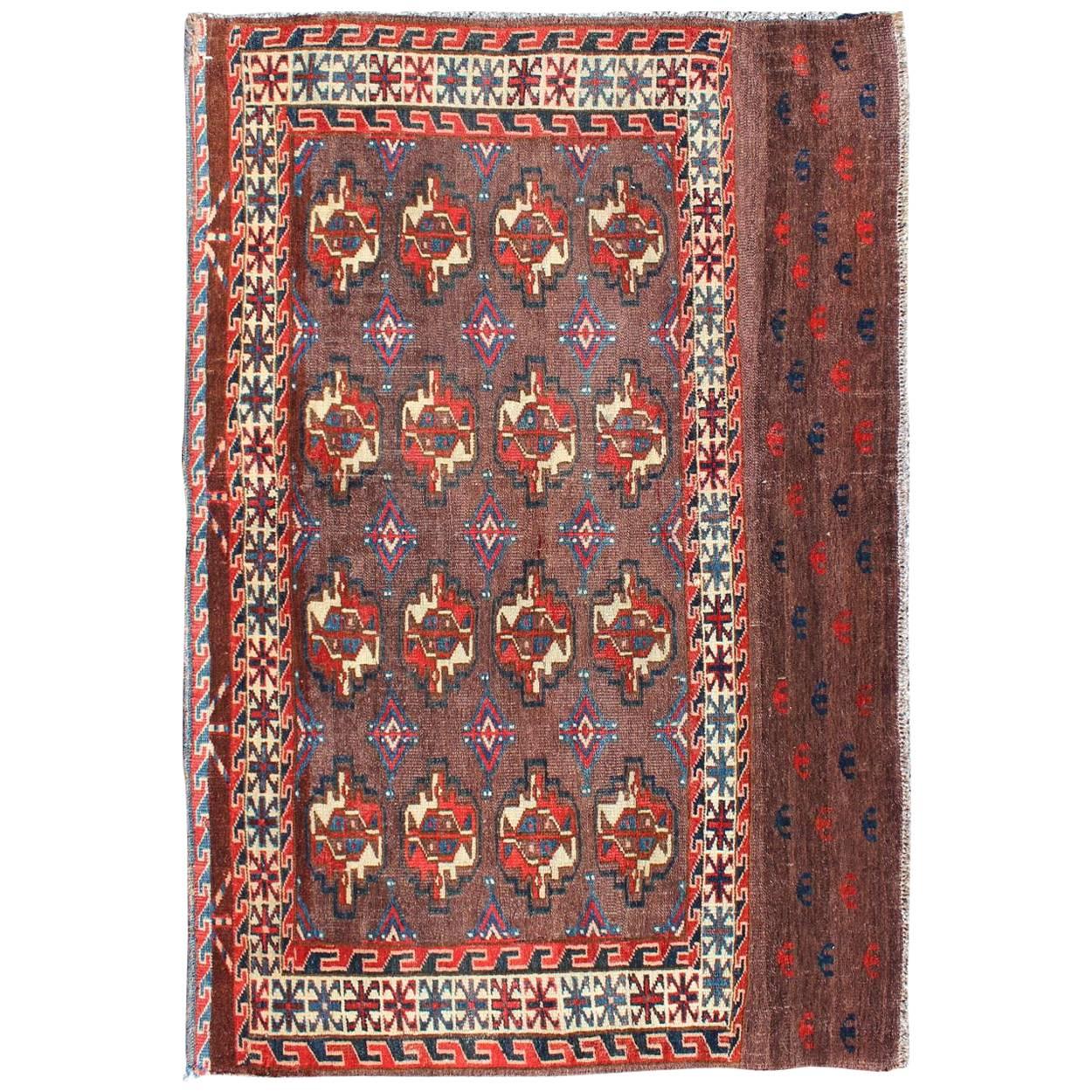 19th Century Antique Tekke Rug with Brown Field and Tribal Motifs in Red For Sale