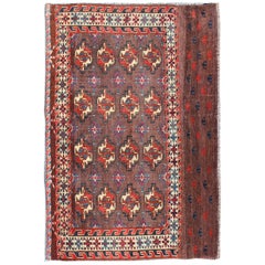 Tappeto Tekke antico del XIX secolo con campo marrone e motivi tribali in rosso