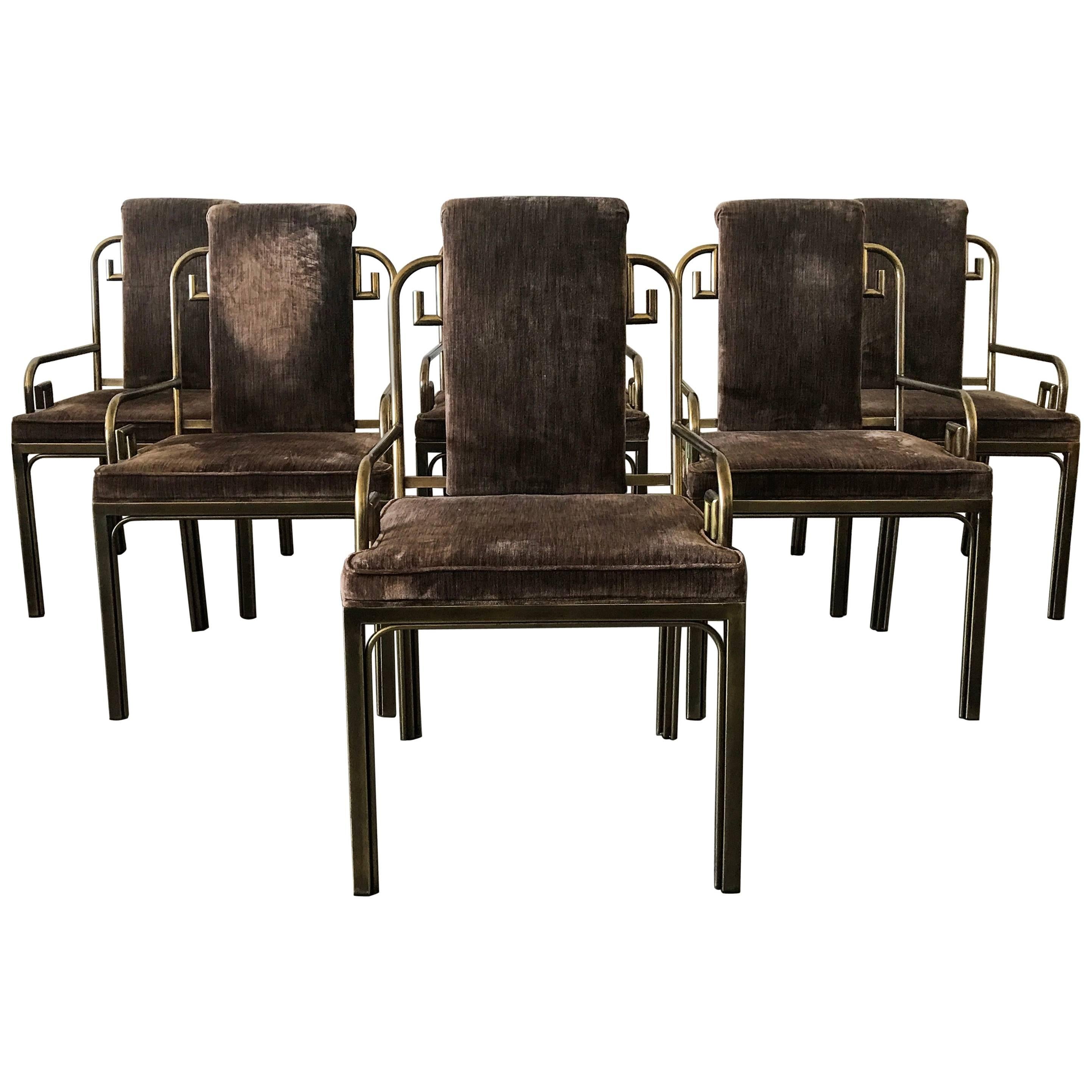 An absolutely stunning set of six Mastercraft brass Greek key dining chairs upholstered in a luxurious brown velvet with a wonderful patina on the brass.