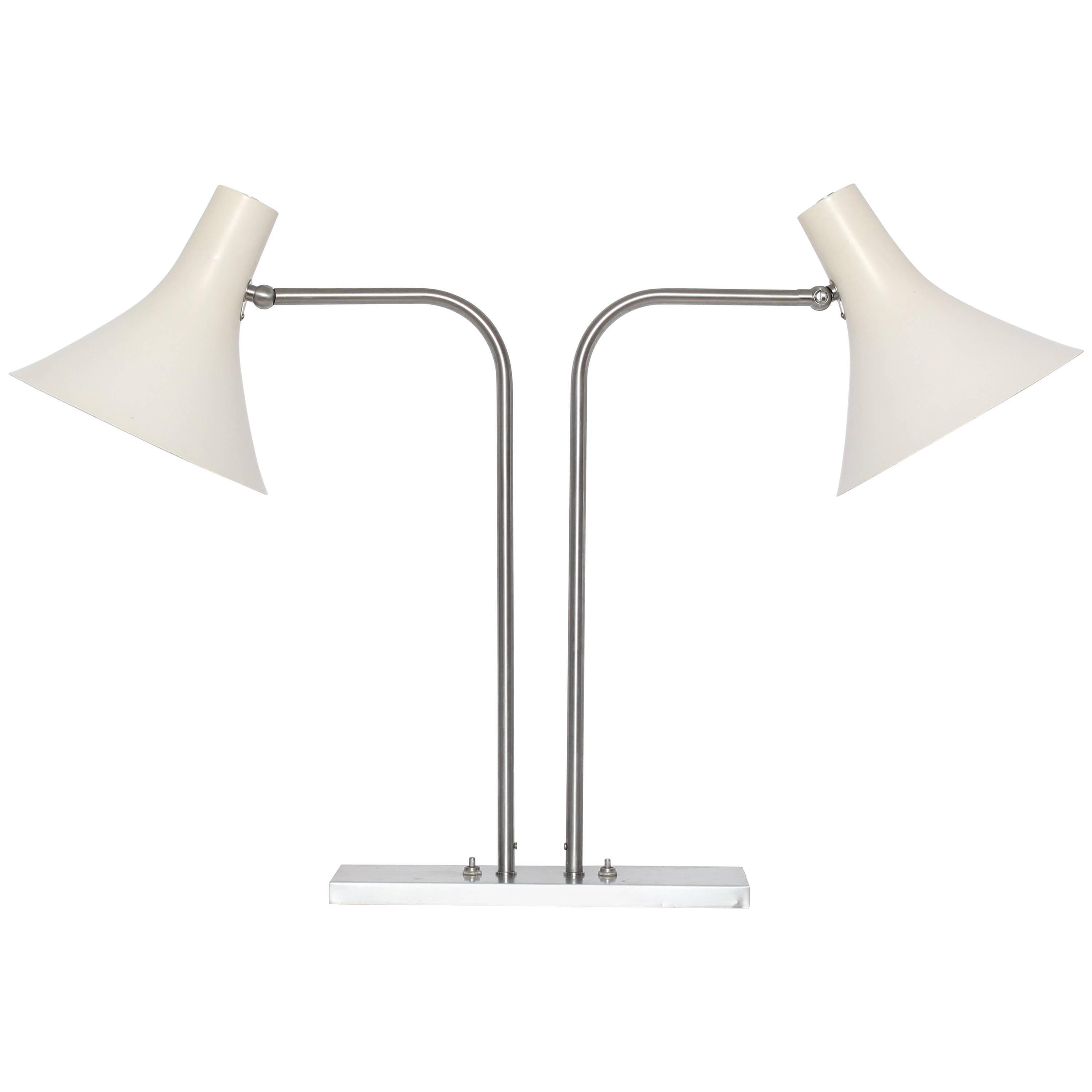 Nessen Studios Double Cone Brushed Nickel  Articulating Library Lamp with Two White Shades. Featuring a rectangular Brushed Nickel Plated Brass base (4 x 12) with two adjustable and perforated White enameled metal Shades. Modern. Circa 1960s.