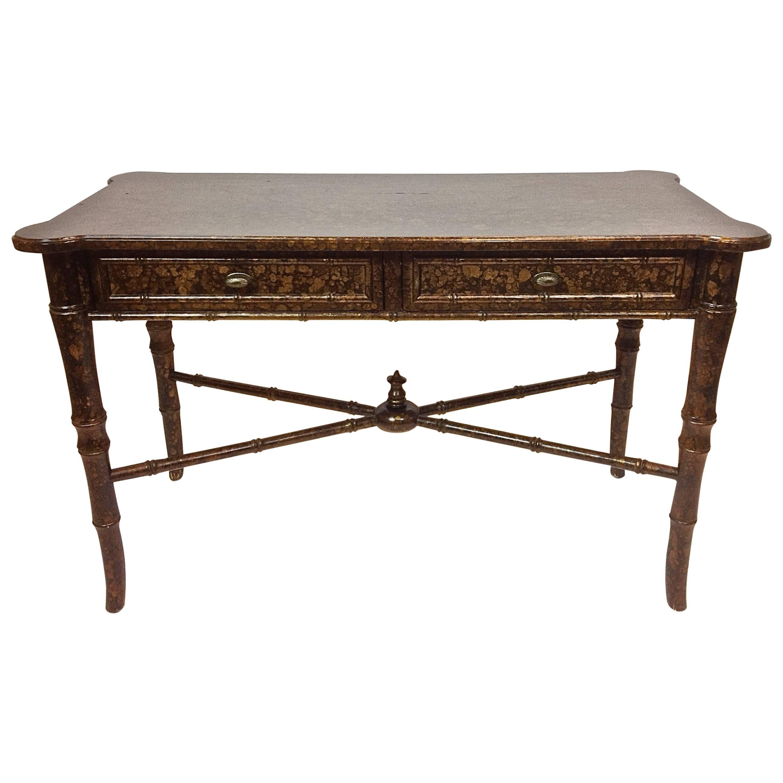 Fantastic wood writing table/desk in faux tortoise shell and bamboo design. Two drawers with metal pulls. Design includes lower crisscross rungs with centre dome detail. The matching chair is just as fantastic in the same tortoise shell and bamboo