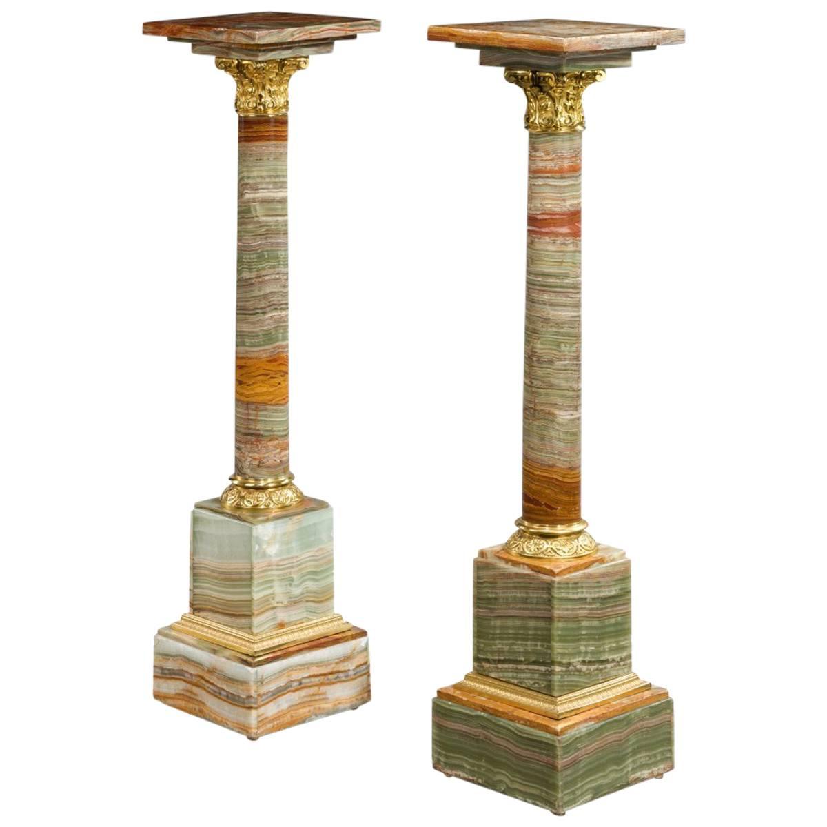 Pair of Amber Colored African Onyx Columns with Revolving Tops