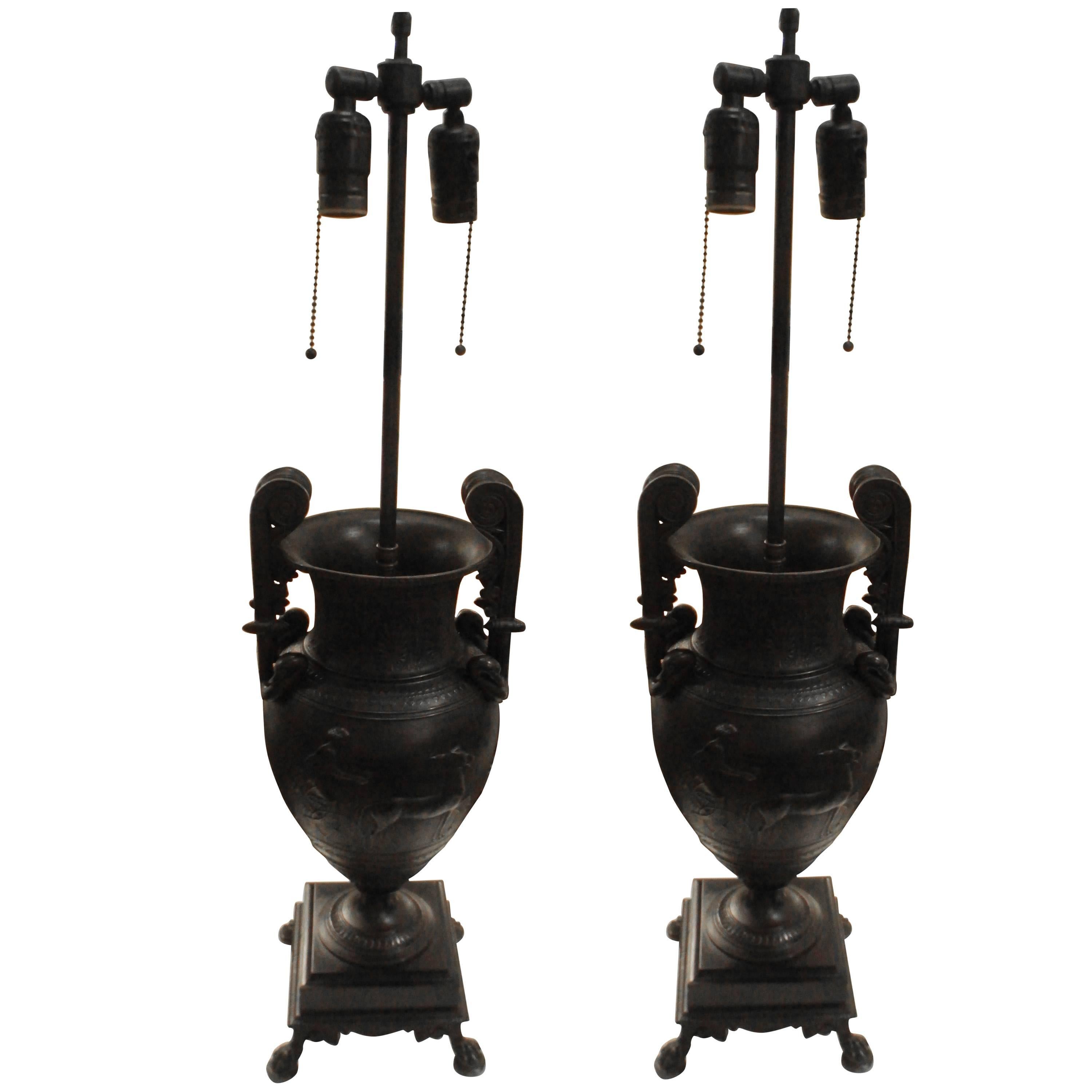 A pair of Empire style bronze lamps.