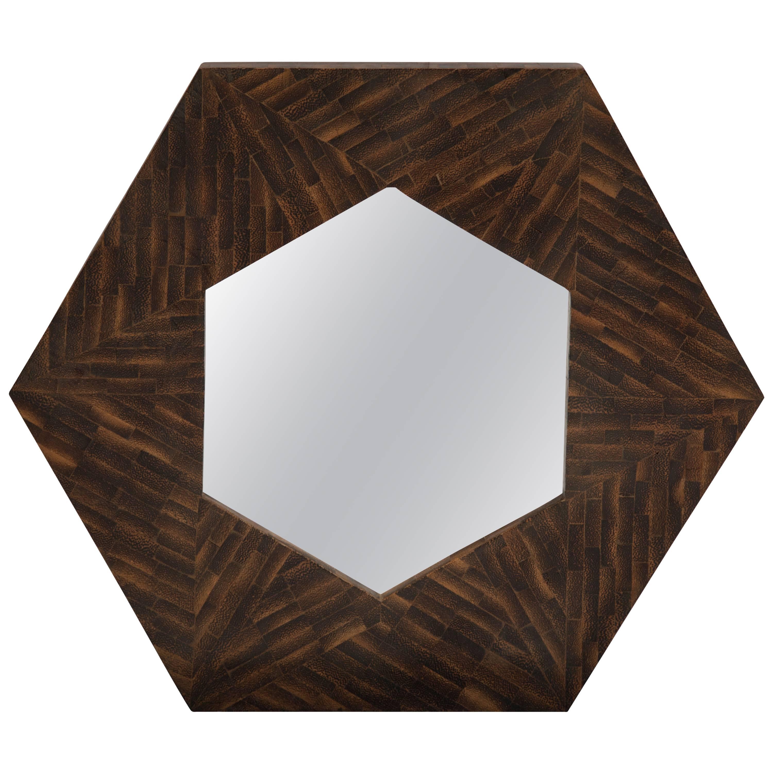 Unknown artist of a unique modernist solid rosewood wall mirror with five sides. Pristine mirror center, circa 1950s. Although the artist is unknown, we believe the origin of this piece is from Italy as the trend for octagonal-shaped mirrors during
