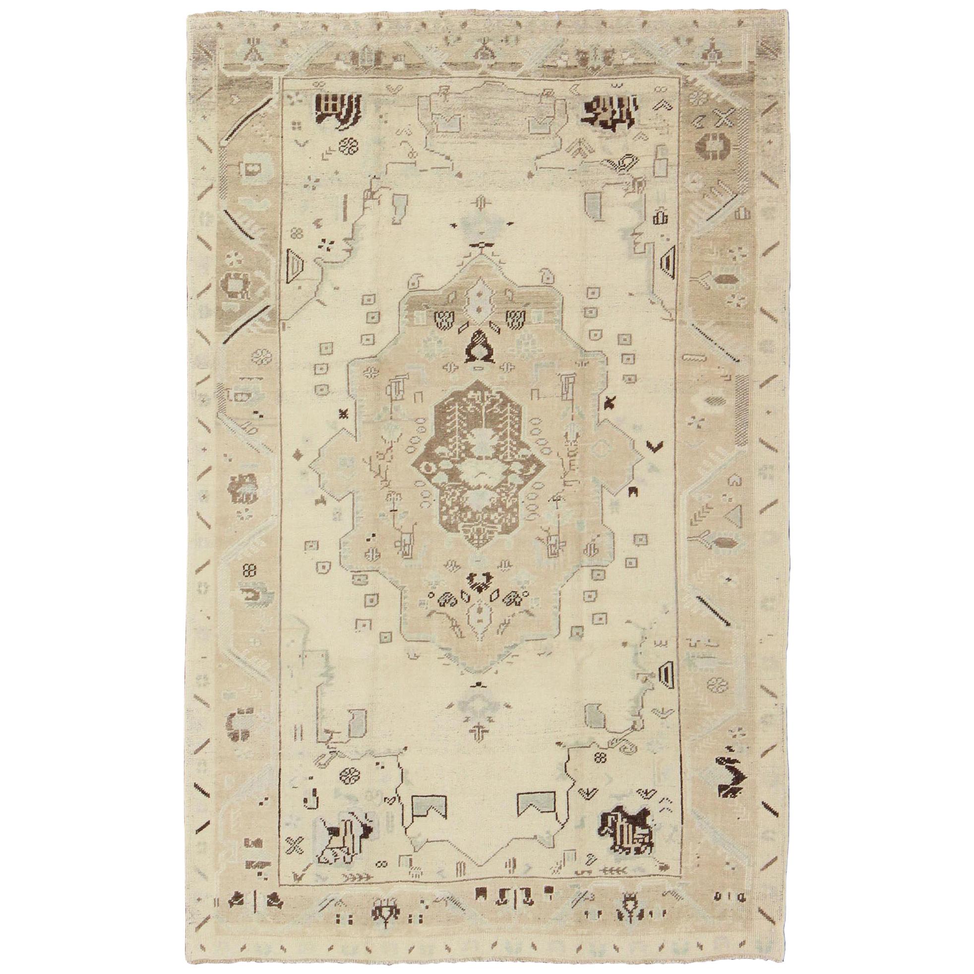 Ivory Background Vintage Turkish Oushak Rug with Tribal Medallion and Motifs For Sale