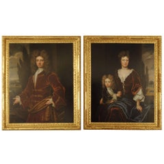 A large pair of 18th century portraits in gilded frames