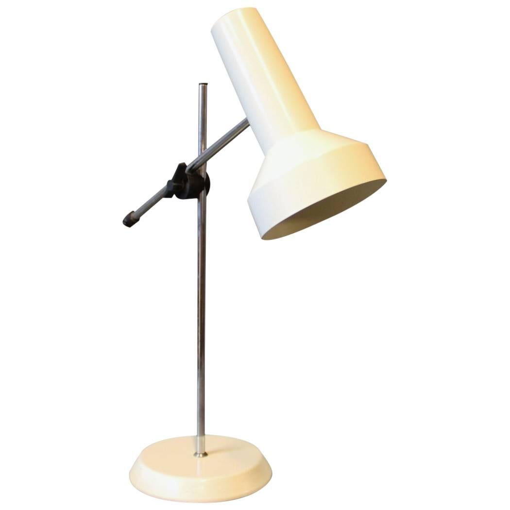 This desk lamp, with its white lacquered shade and foot, was designed by the renowned Danish company Fog & Mørup in the 1960s. Fog & Mørup was established in 1904 by Ansgar Fog and Erik Mørup and quickly became a significant name in Danish lighting