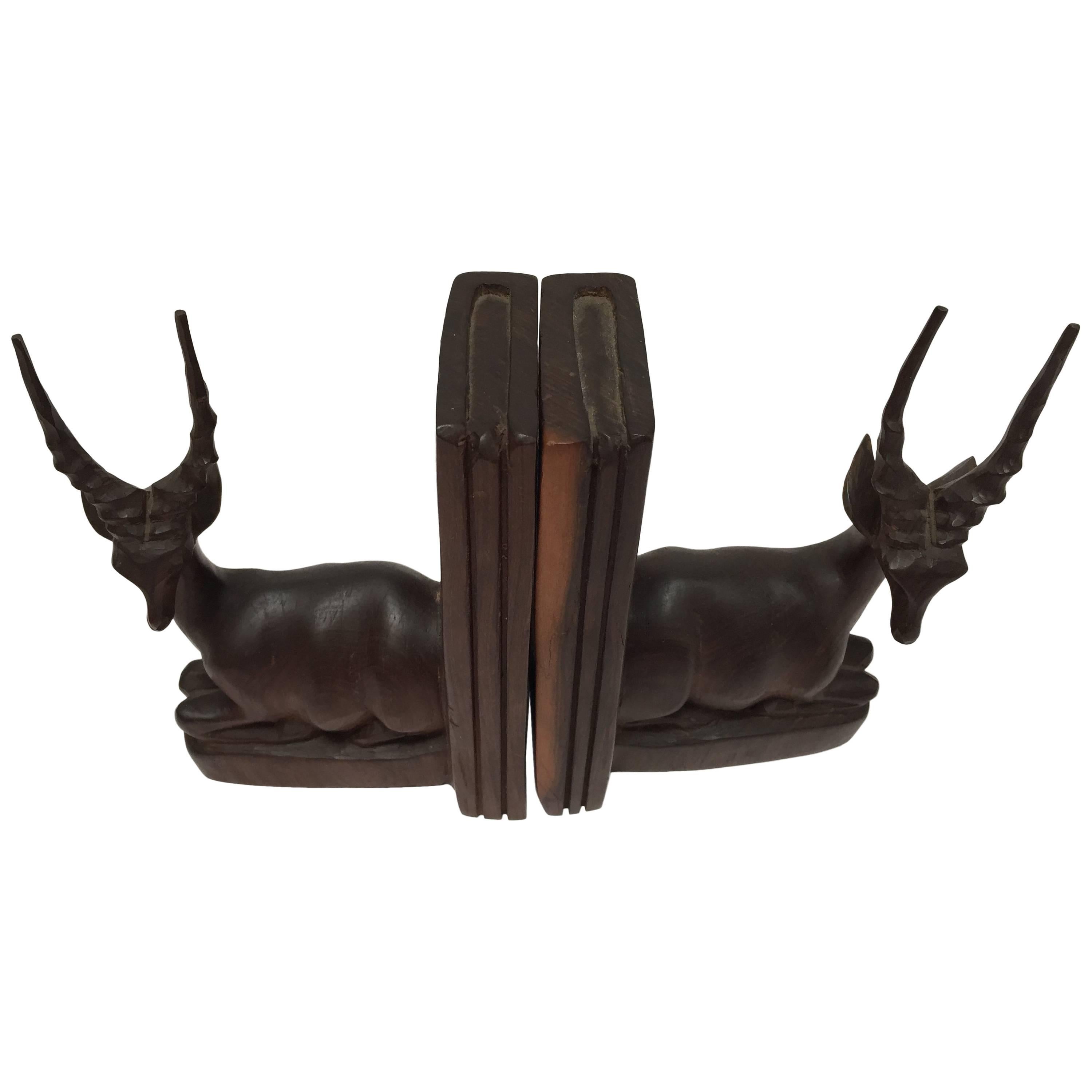 Nice pair of hand-carved  Mid-Century Deer Antelope bookends
Pair of carved wood bookends of African antelopes.
These are hand-carved and therefore not completely identical.
circa 1950 
Size for each piece is 8.25 in H. x 8.25 in W. x 4in