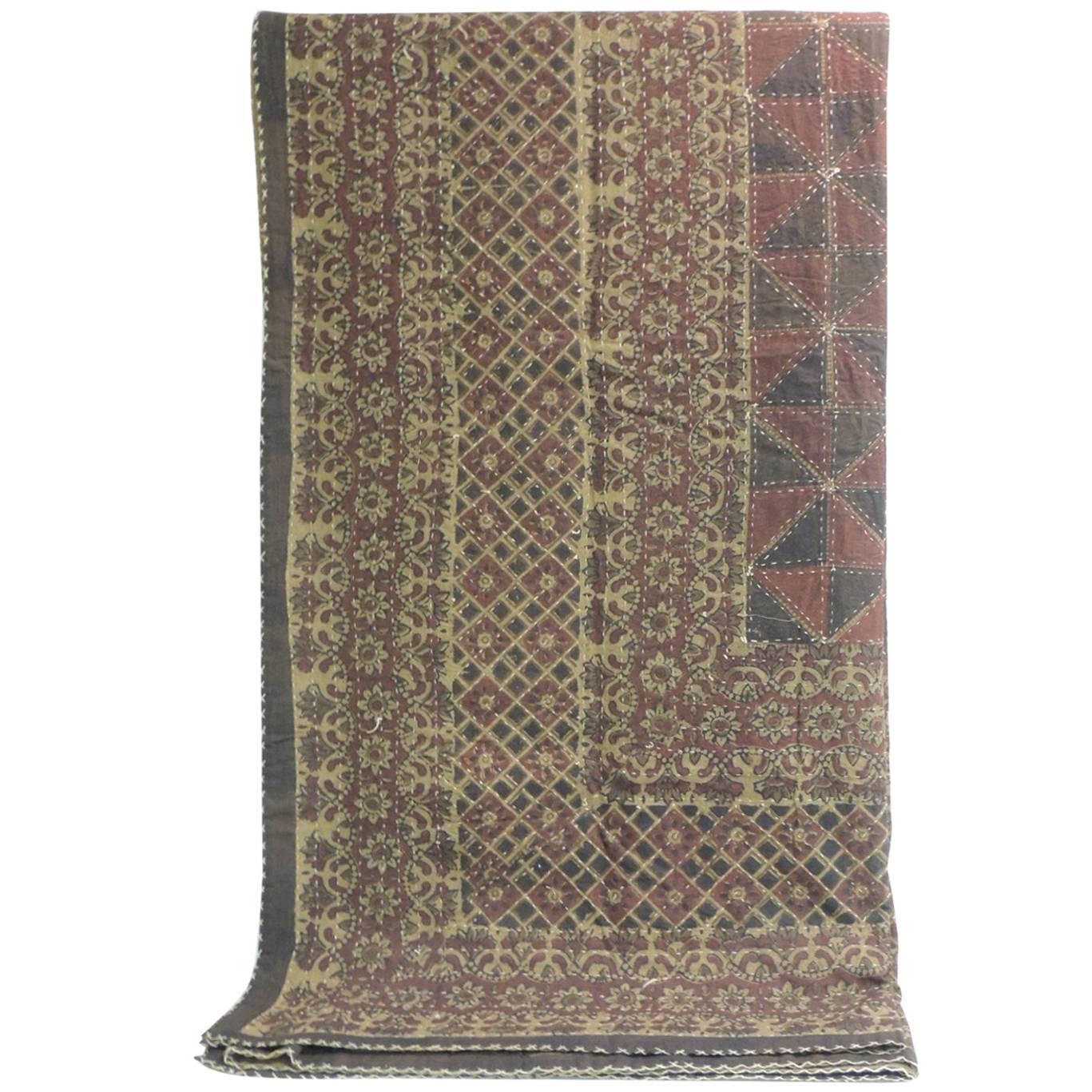 Large vintage quilted Indian Kantha king size blanket. In shades of red. brown, tan, yellow, red, deep blue and natural.
Kantha quilts alongside jamdani are the pride of Bengal (a geopolitical, cultural and historical region in Asia in the