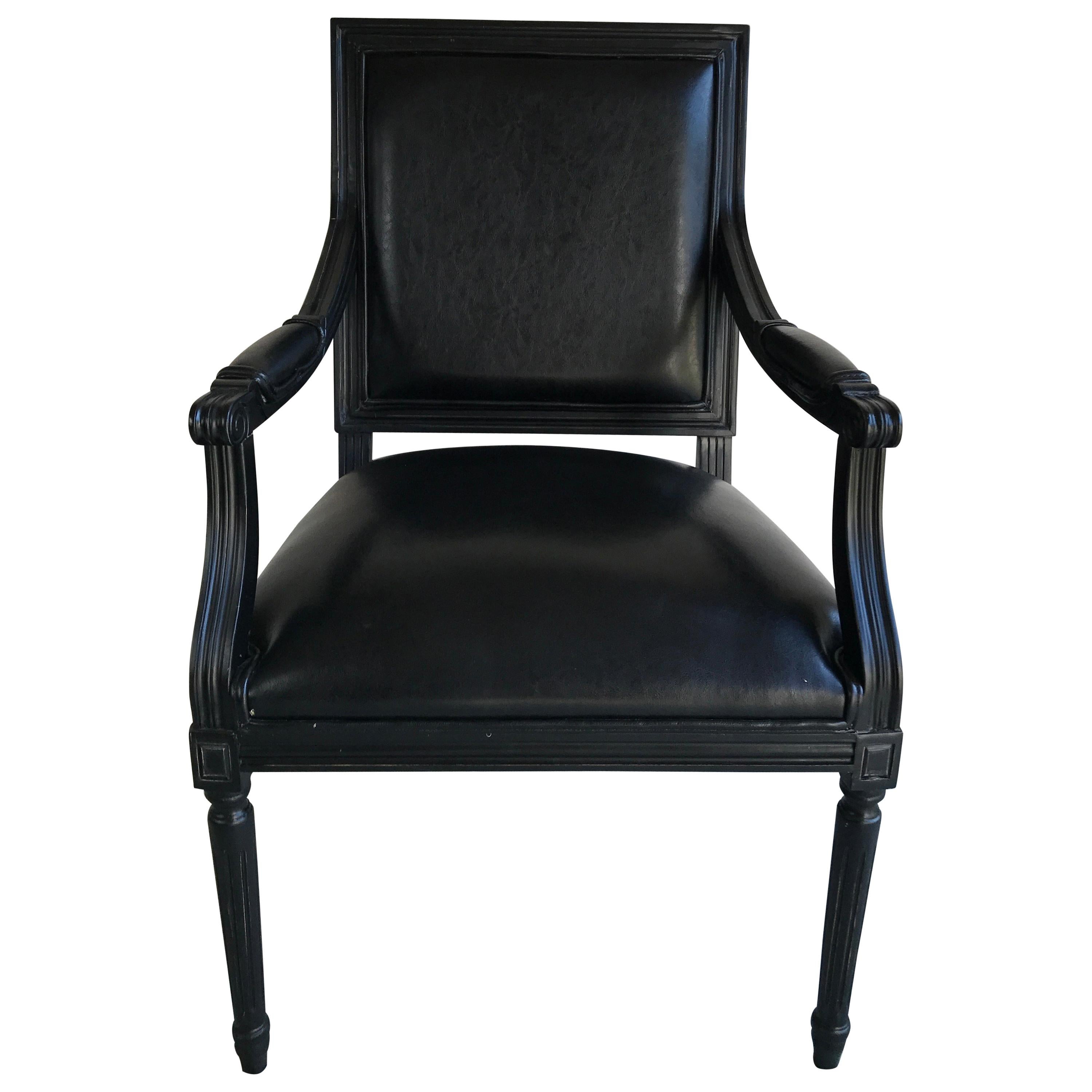 A pair of black painted Directoire style armchairs with black leatherette upholstery. Wonderful square design with a monochromatic finish.