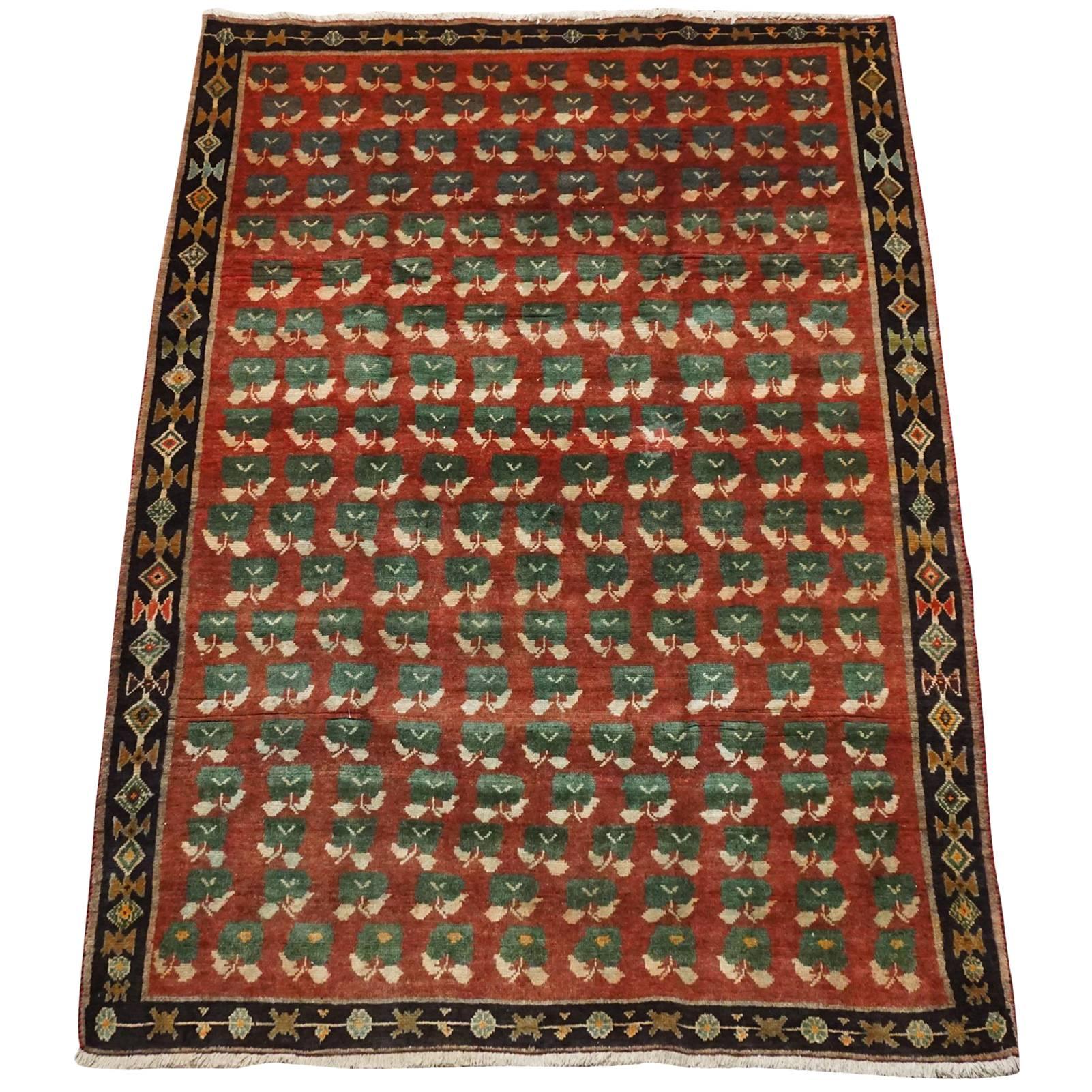 Antique Persian Tribal Rug with Flower Motif, circa 1940 For Sale