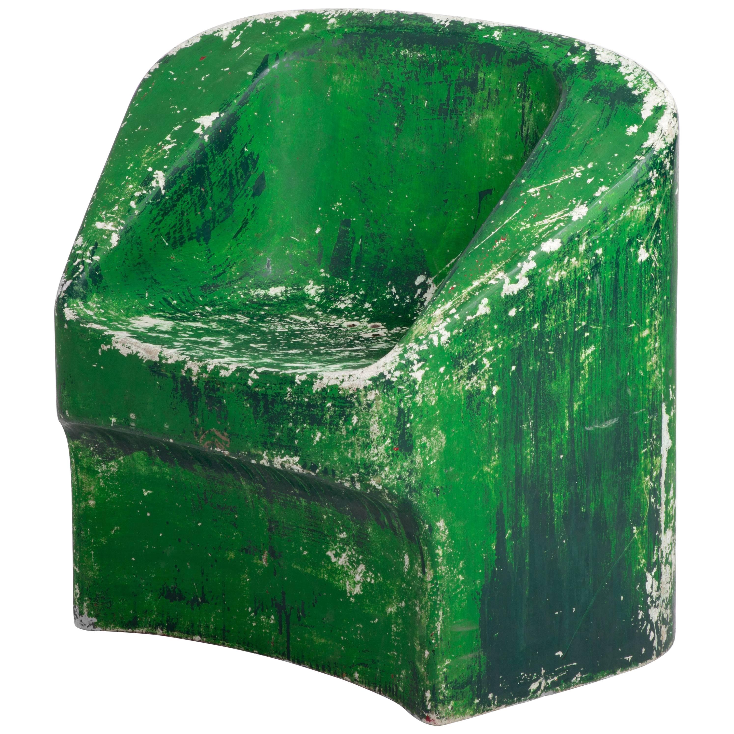 From Swiss designer Willy Guhl this is a fiberglass cement chair in distressed green. Guhl was a creator of innovative and neo-functional furniture, he was also one of the pioneers for flat-pack furniture. 

 