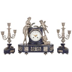 Antique French Lapis Lazuli and Silvered Bronze Three-Piece Clock Set