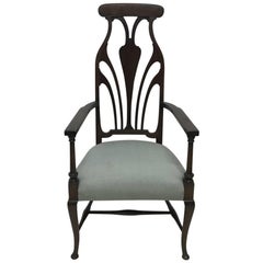 Liberty & Co. An Arts & Crafts Mahogany Armchair with an Art Nouveau Style Back 