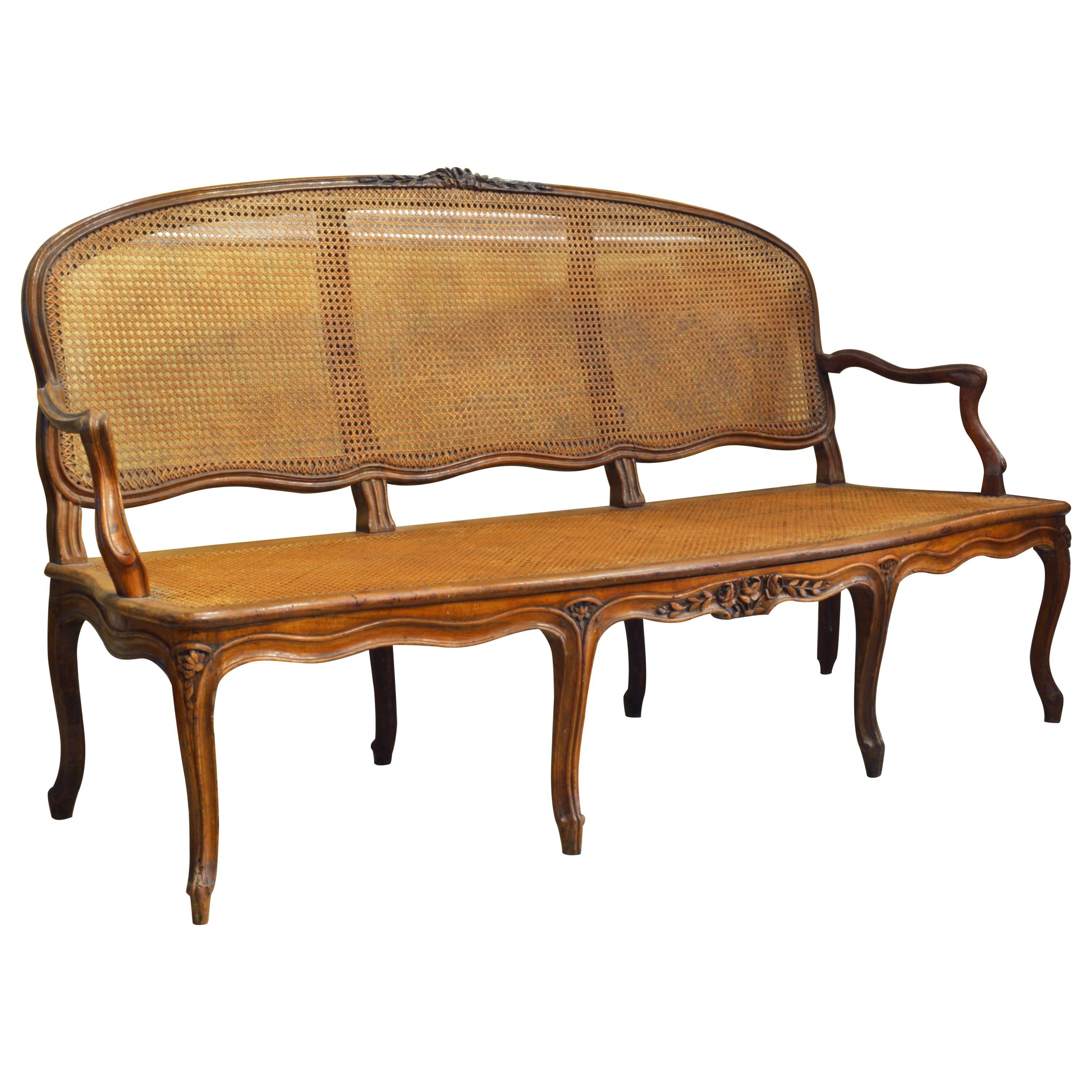 Late 18th Century Provincial Louis XV Style Carved and Caned Walnut Settee
