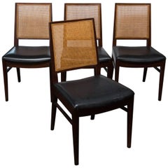 Set of Four John Stuart Walnut and Caned Dining Chairs