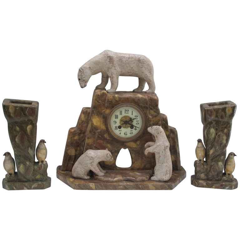 Wood polar bears on mantel clock with pair of vases with penguins, 1920s