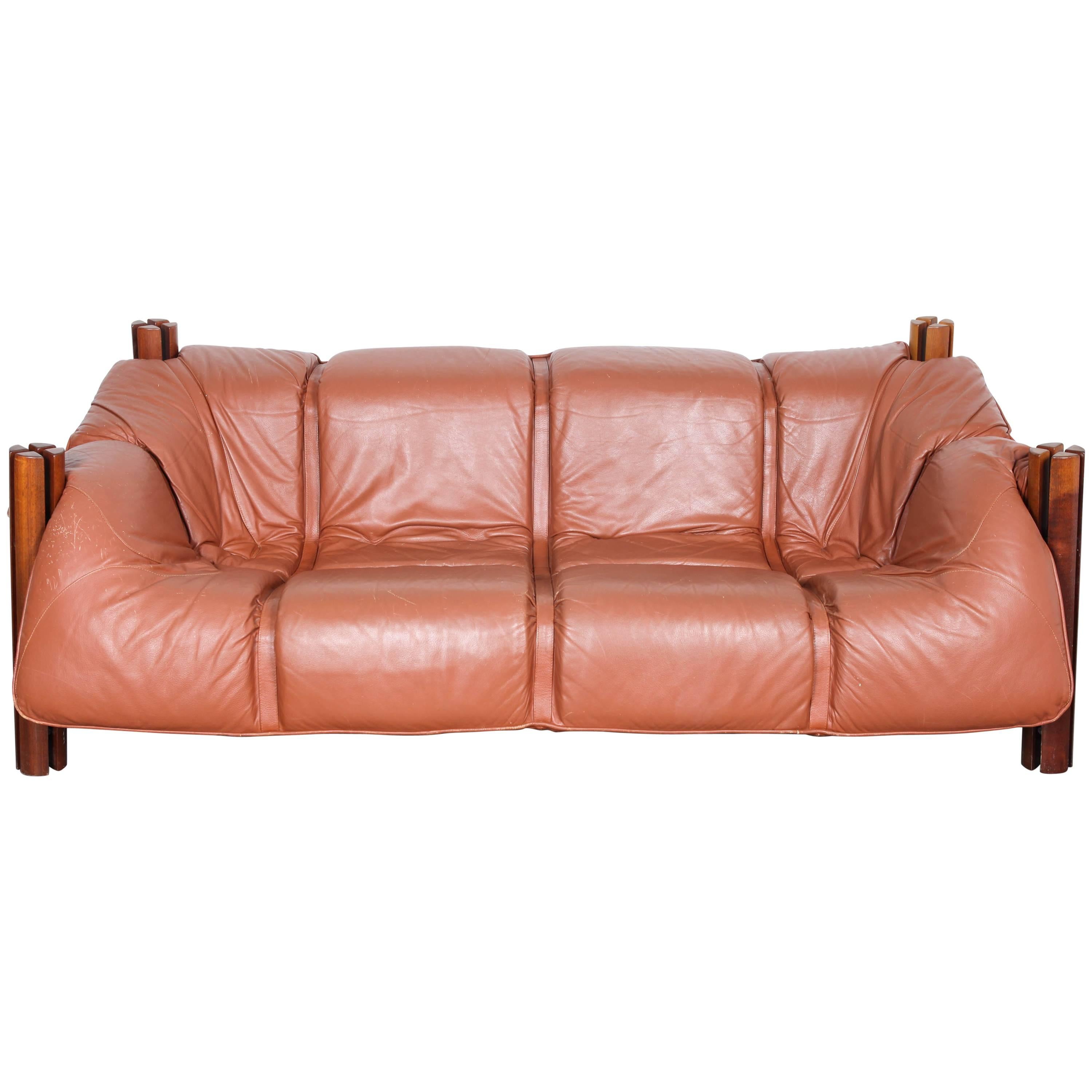 Percival Lafer, MP-211 sofa supported by round quarter-split posts. This piece has a singular leather cushion which conforms around the frame. Matching two-seat and lounge chair also offered. Please see Midcenturyla store.
