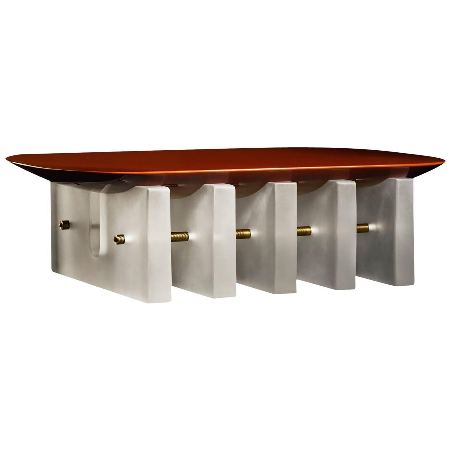 The translucent resin bases of the Segment series lift softly-rounded forms, creating a visual play between density and lightness. The underside of the lacquer table tops bulge as though being pulled back to the floor, anchoring one form to the