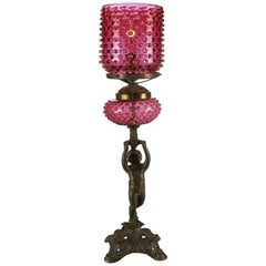 Antique Bronze Cherub Figural Table Lamp with Cranberry Hobnail Shade and Font
