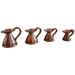 Matched Set of Four Small 19th Century Copper Pitchers with Stamps