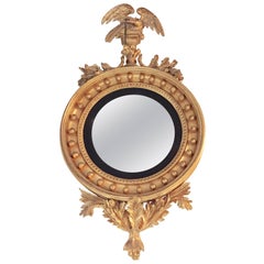 Antique Federal Style Convex Mirror Ebony and Gilt Adorning an Eagle Winged Crest