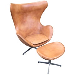 Vintage Cognac Leather Egg Chair and Footstool by Arne Jacobsen for Fritz Hansen