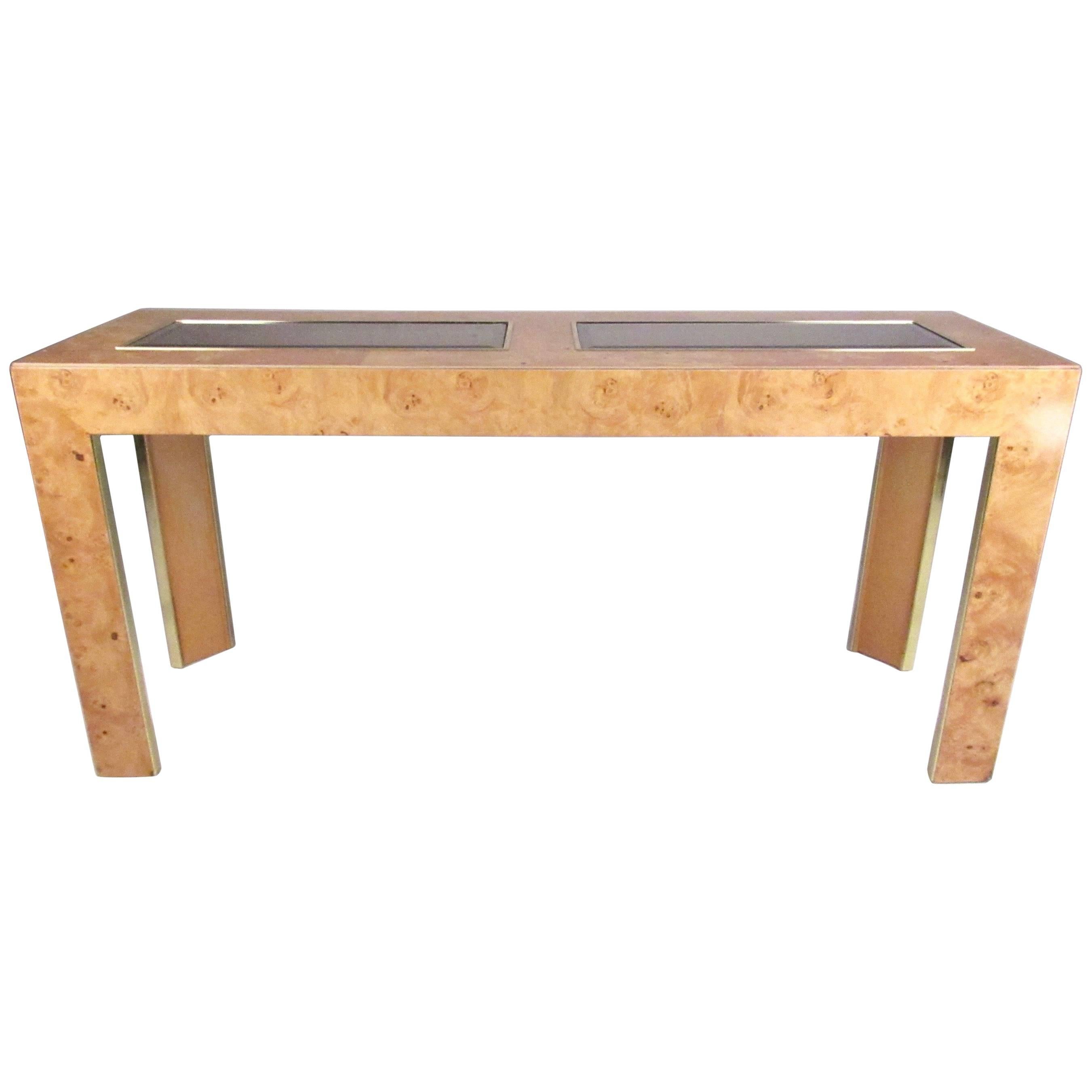 This stylish vintage modern console features maple burl wood finish and two pieces of smoked glass inlaid. Brass finish trim adds to the midcentury appeal of this vintage American table, making it the perfect addition to entryway, hall, or office.