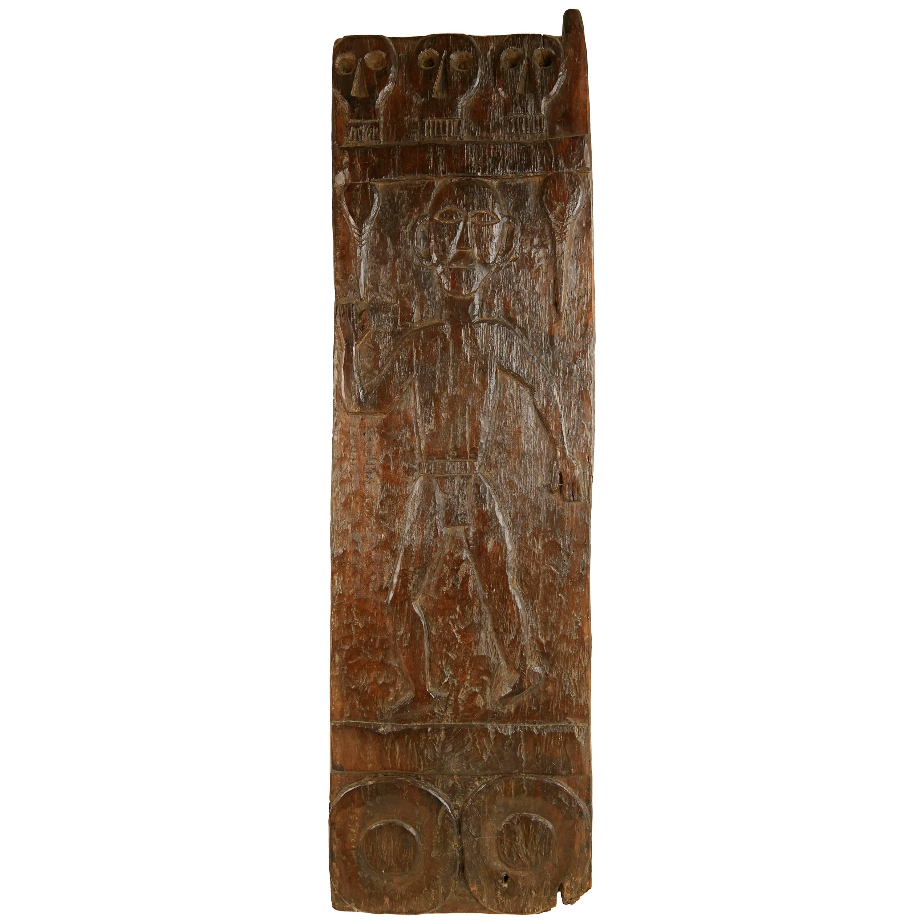 African Wooden Granary Door with Carved Motifs and Sculls