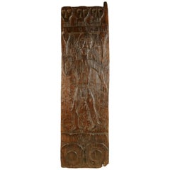 African Wooden Granary Door with Carved Motifs and Sculls
