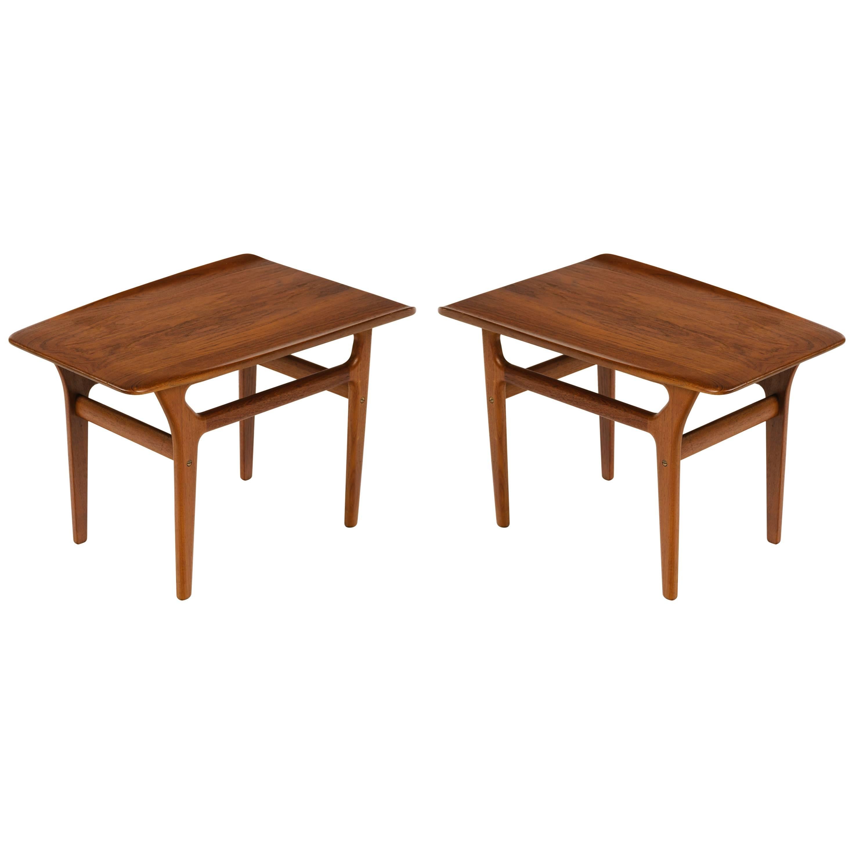 Pair of teak Mid-Century Modern end tables with streamline design. Fabulous sleek angles throughout, with tapered leg design and slightly curved tops. Stamped Denmark on the underside of tables.