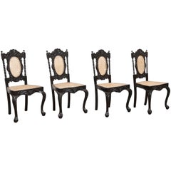 Four Mid-19th Century Exquisitely Carved Solid Ebony and Cane Side Chairs