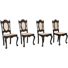 Four Mid-19th Century Exquisitely Carved Solid Ebony and Cane Side Chairs