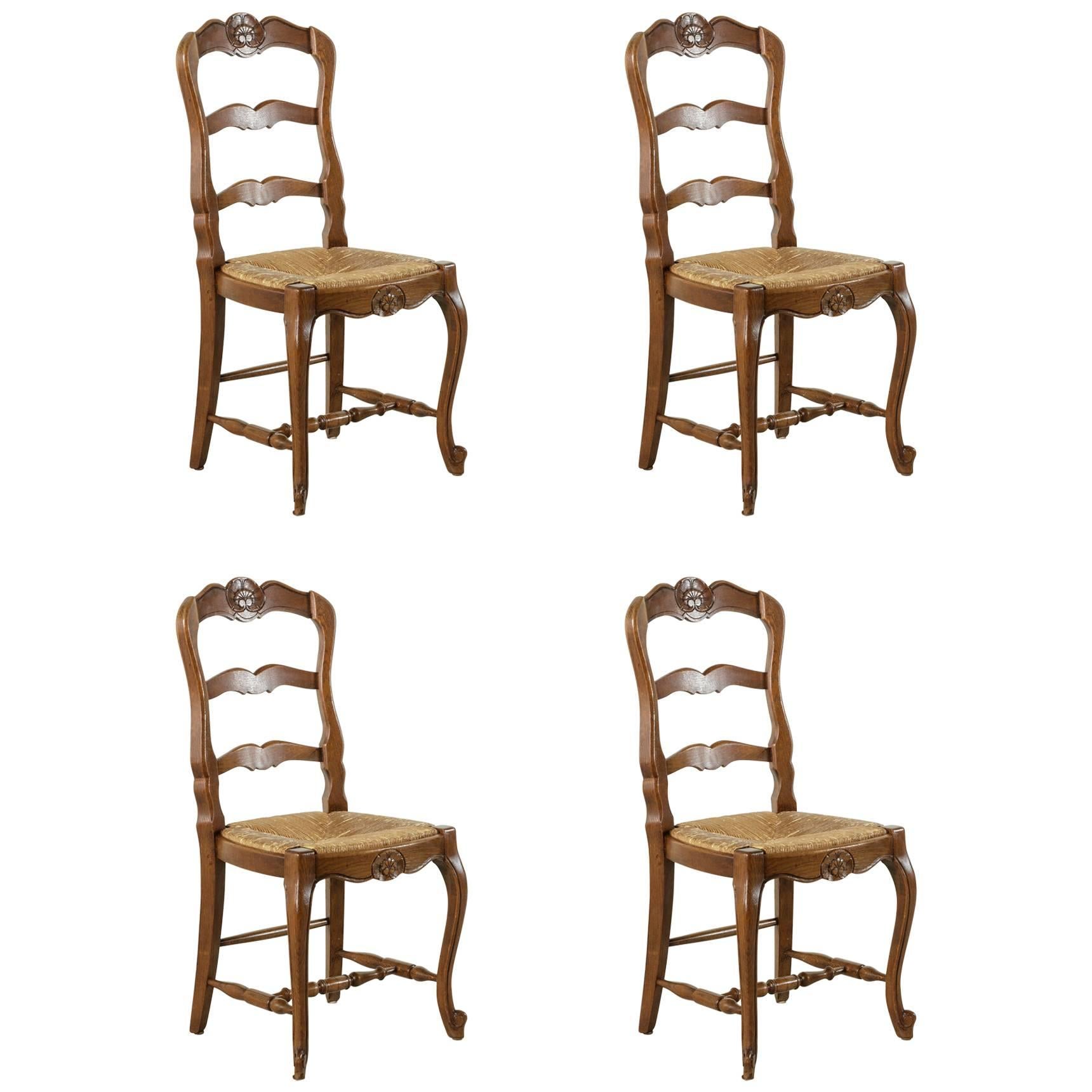Set of Four French Louis XV Style Carved Oak Chairs with Rush Seats
